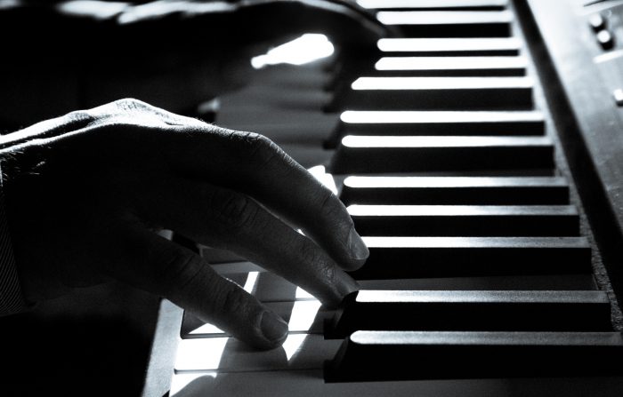 man playing piano keys