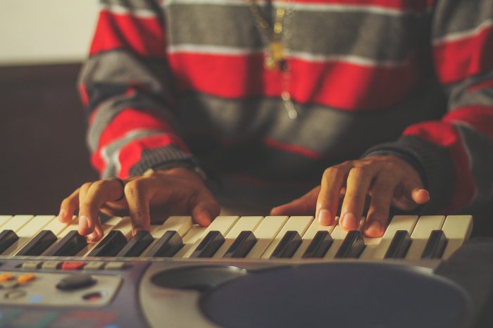 young man playing midi keyboard