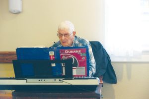 old man at piano