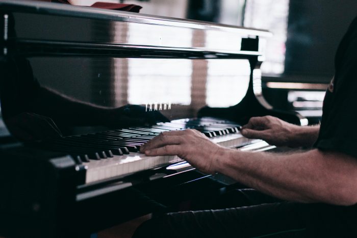 man playing Yamaha piano