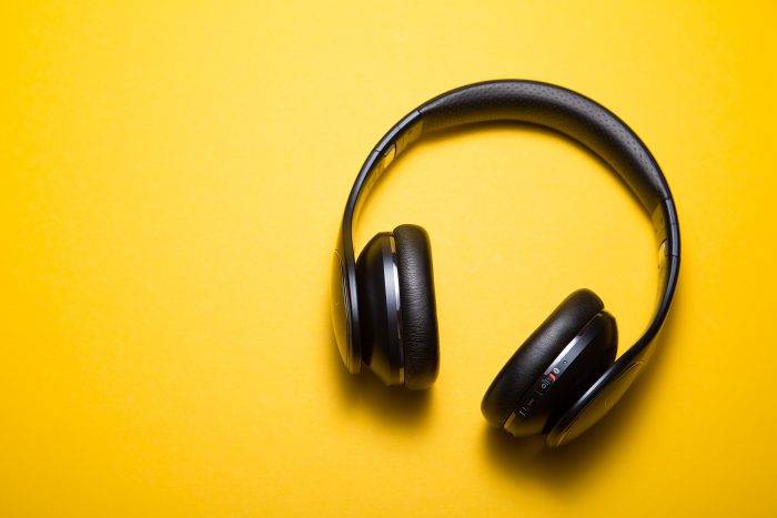 black headphones on yellow background