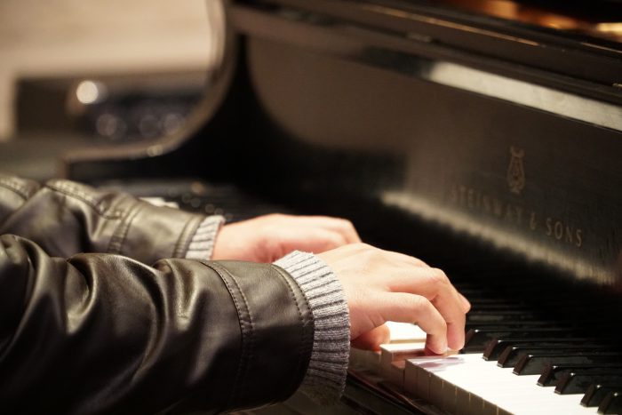 piano player with jacket and sweater